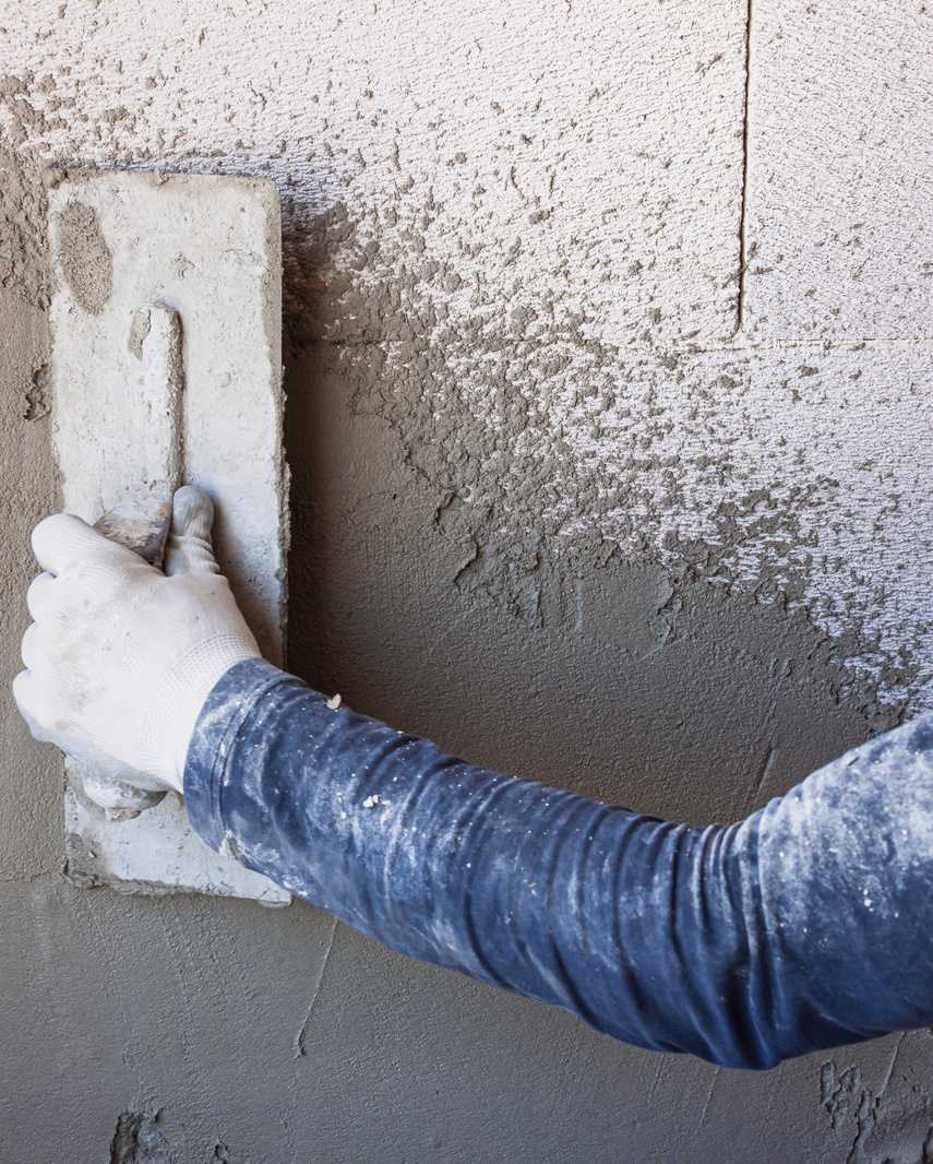 Worker plastering tool plaster marble on interior plaster rough